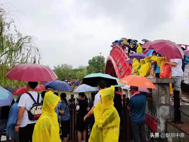 河南开封：雨中的清明上河园景美游人兴致更憨